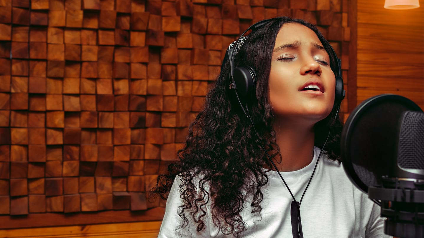 Person speaking/singing into a microphone