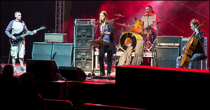 band performing on stage with a set list