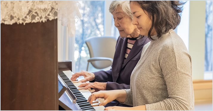 therapist and elderly patient enjoying music therapy