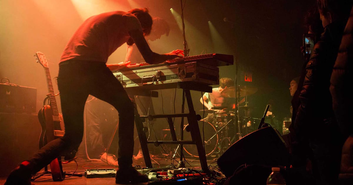 keyboardist on stage playing in live band