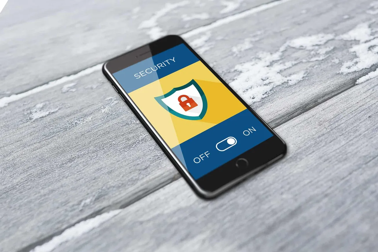 Secure mobile phone with security shield icon and toggle switch on screen, concept of digital security, online security, data