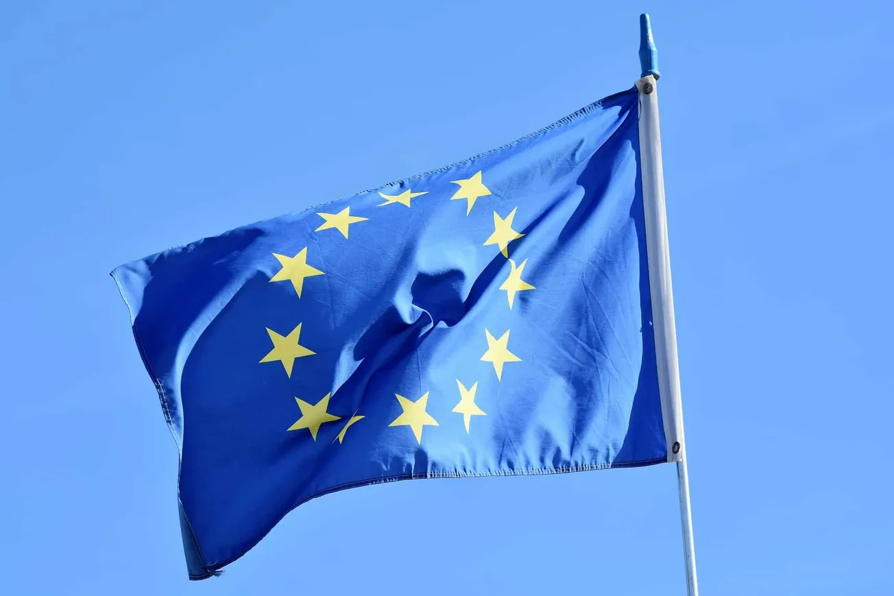 EU flag flying in the wind against a clear blue sky, symbolizing European unity, politics, and community. Ideal for discussio