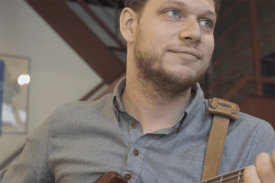 Guitar player at an indoor music event, emphasizing live music and entertainment content.