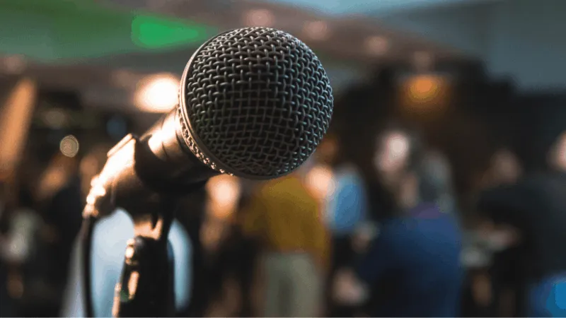 Microphone on stage at a music industry event, ready for a live performance or speaking engagement for artists and music prof