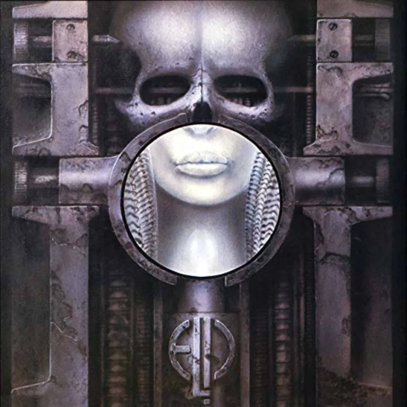 A futuristic metallic sculpture featuring a human face with a skull overlay, surrounded by industrial elements; representing