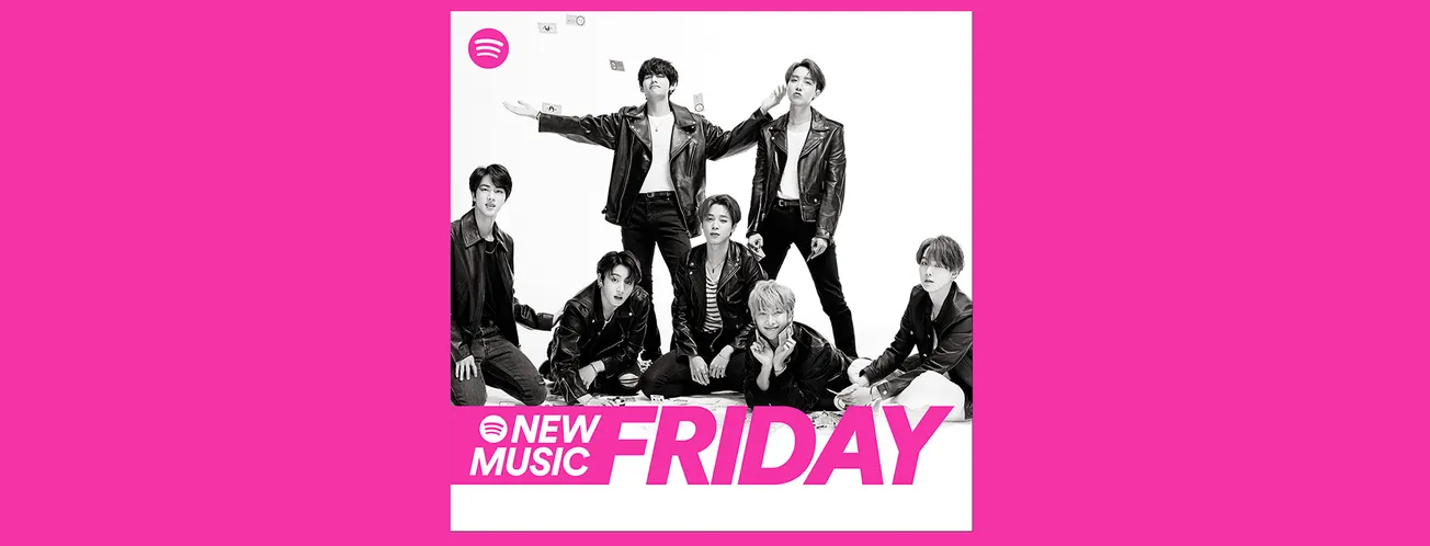 Charming K-pop group members in stylish leather jackets posing for promotional photo with vibrant pink background and Spotify