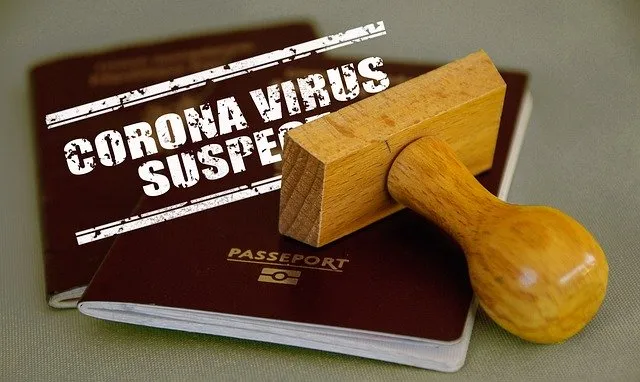 Passport with "corona virus suspect" stamp, wooden stamp, travel document, pandemic travel restrictions, health screening, CO