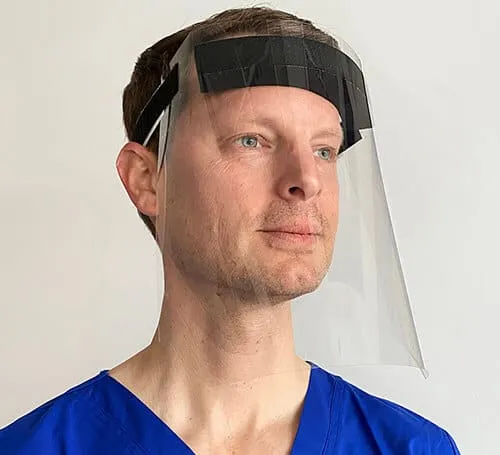 Face of a man wearing a protective face shield, medical professional, PPE safety gear, healthcare worker, virus prevention, h