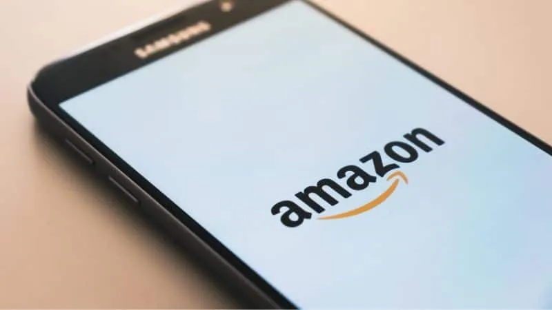Amazon shopping app on smartphone screen, online retail, mobile commerce, e-commerce platform, digital shopping, Amazon logo,