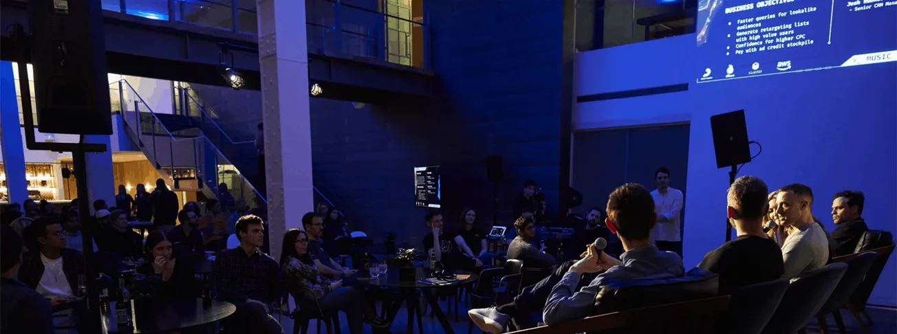 Basketball-themed event with presentation, audience, and stage setup in a modern indoor venue, emphasizing technology and ent