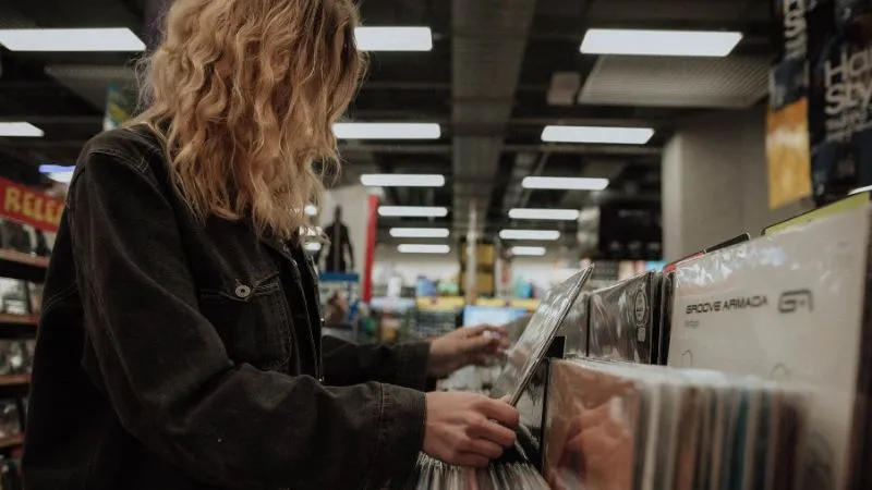 Home shopping vinyl records music store collection music enthusiasts browsing records in store.