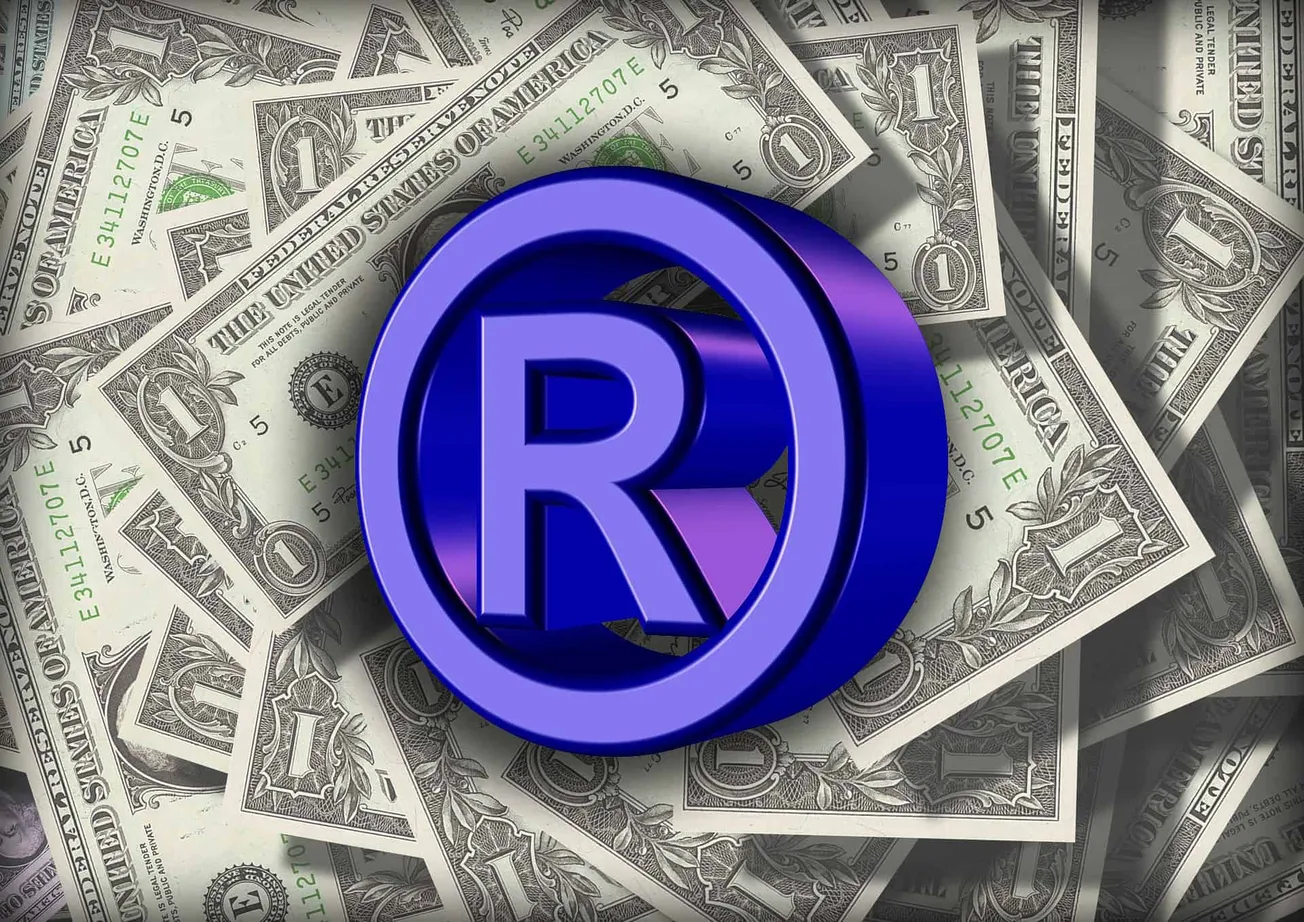 Registered trademark symbol on dollar bills, representing monetization and branding in the music industry.