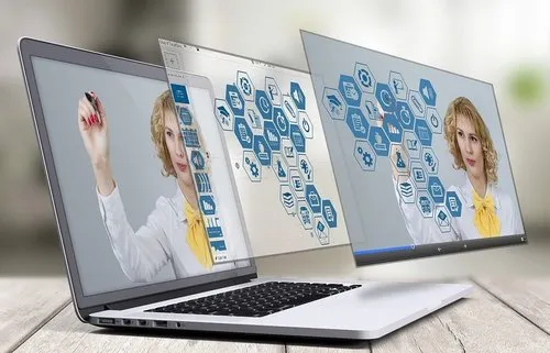 Digital marketing and social media strategy concept with a woman engaging with virtual icons on multiple laptops, emphasizing