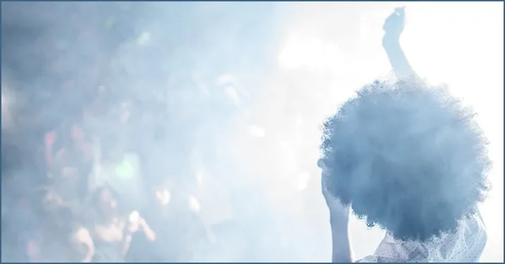 Vibrant concert crowd with a performer on stage, emphasizing live music events and entertainment industry.