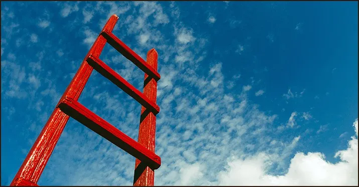Risky ladder against blue sky with clouds, symbolizing challenges and growth in the music and entertainment industry, related