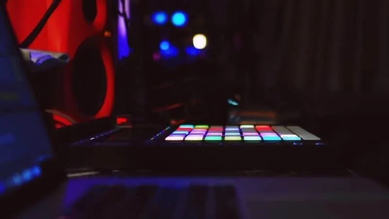 Lighting-controlled DJ equipment with colorful pads and audio gear at a music studio or club, ideal for music production, DJ