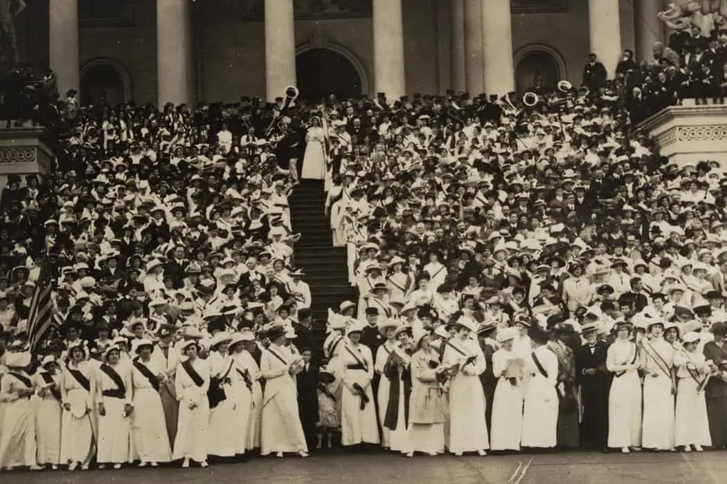 Massive crowd of people gathered on steps of government building, historic black and white photograph, early 20th-century pub