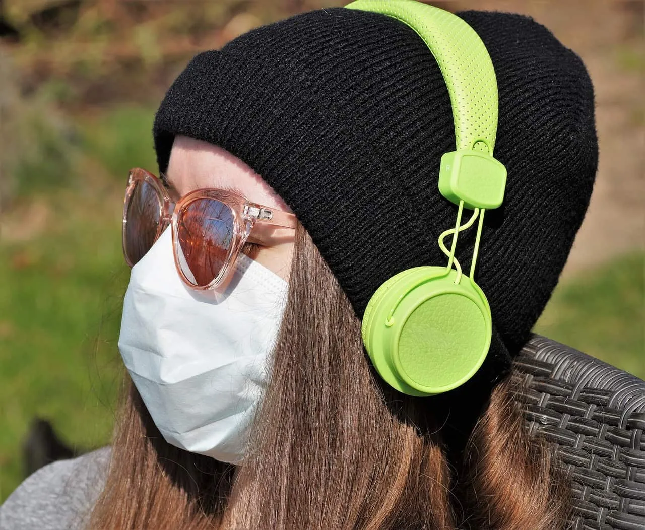 Headphones, woman wearing black beanie and sunglasses with face mask outdoors, modern wireless headsets, outdoor listening, s