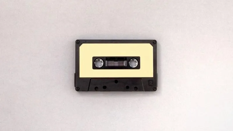 Vintage cassette tape on a plain background, representing music, audio, and media storage.
