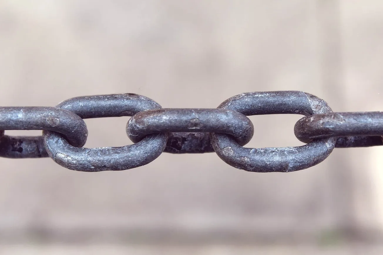 Rusted metal chain links for industry or security purposes, close-up image.
