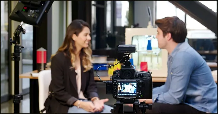 Interview recording setup with professional camera and lighting for media interview or content creation.