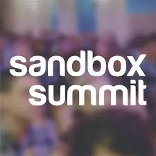 SandBox Summit conference stage with a blurred audience background, technology and music industry event, networking, innovati