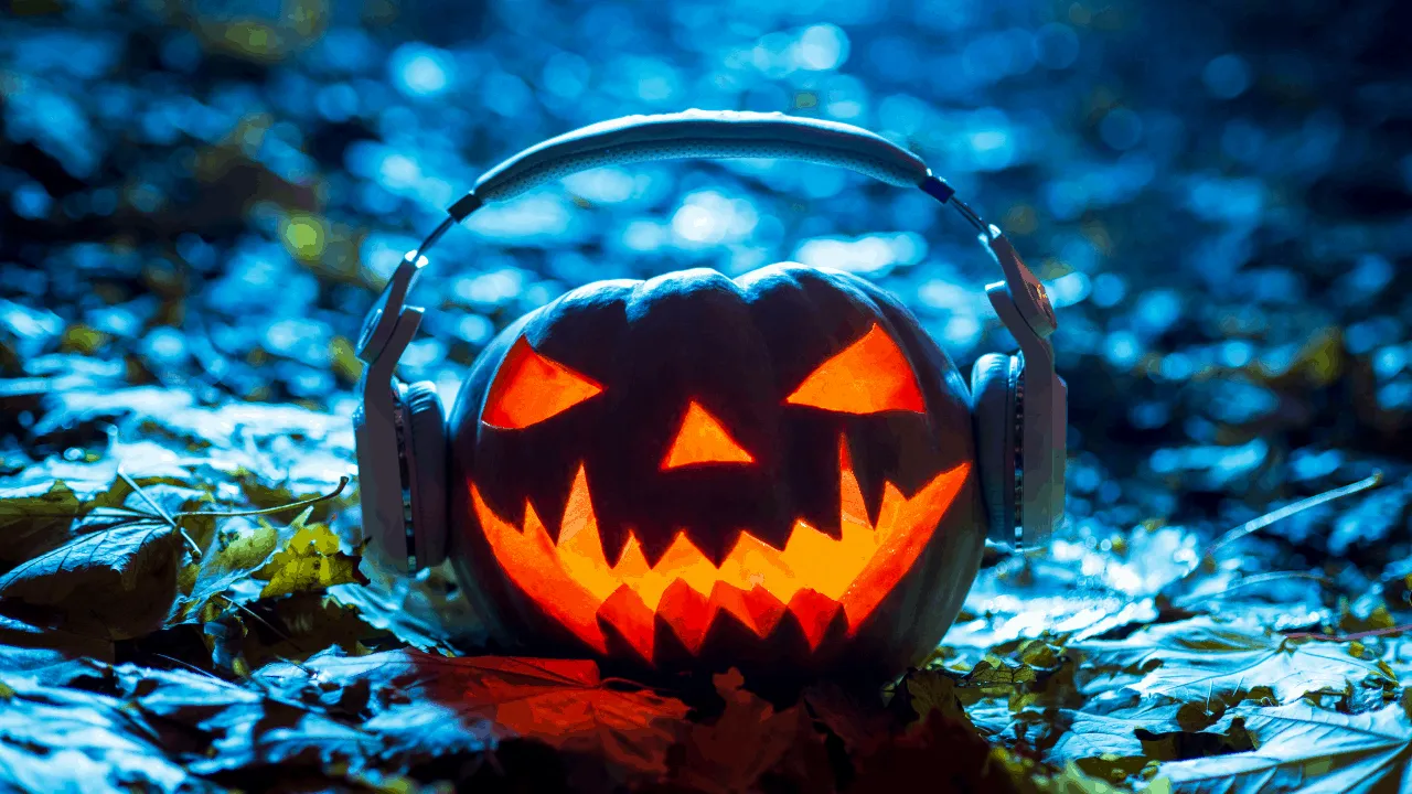 Spooky Halloween pumpkin with glowing carved face wearing headphones on autumn leaves during night.