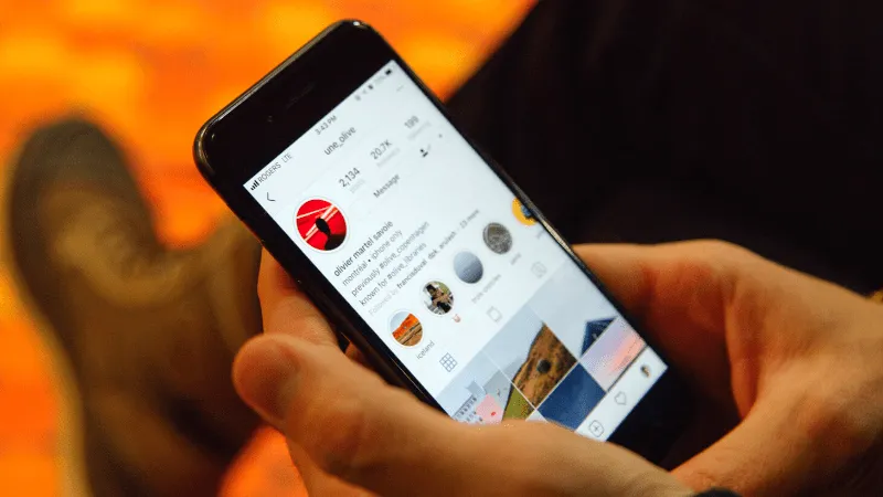 Omnipresent social media phone screen showcasing Instagram profile for music and entertainment promotion.