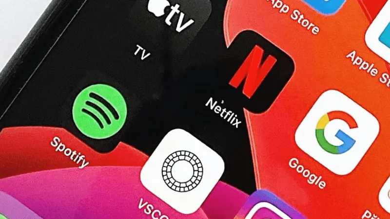 Spotify app icon on a smartphone screen, popular music streaming service, vibrant green logo for digital music access and pla