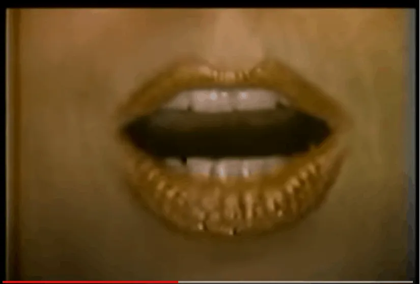 Gold lipstick on lips with black lipstick in the middle, close-up of mouth, fashion, beauty, bold makeup, lip makeup, high fa