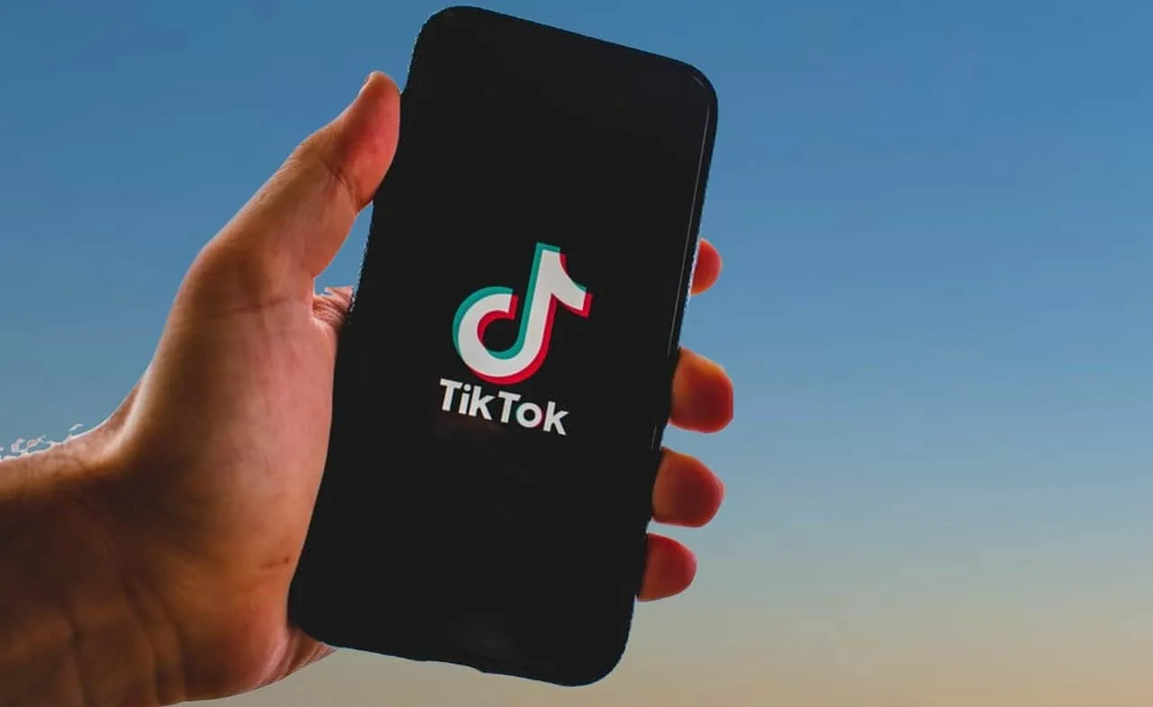 TikTok app on smartphone displaying logo, social media, video sharing, viral content, digital entertainment, mobile device, t