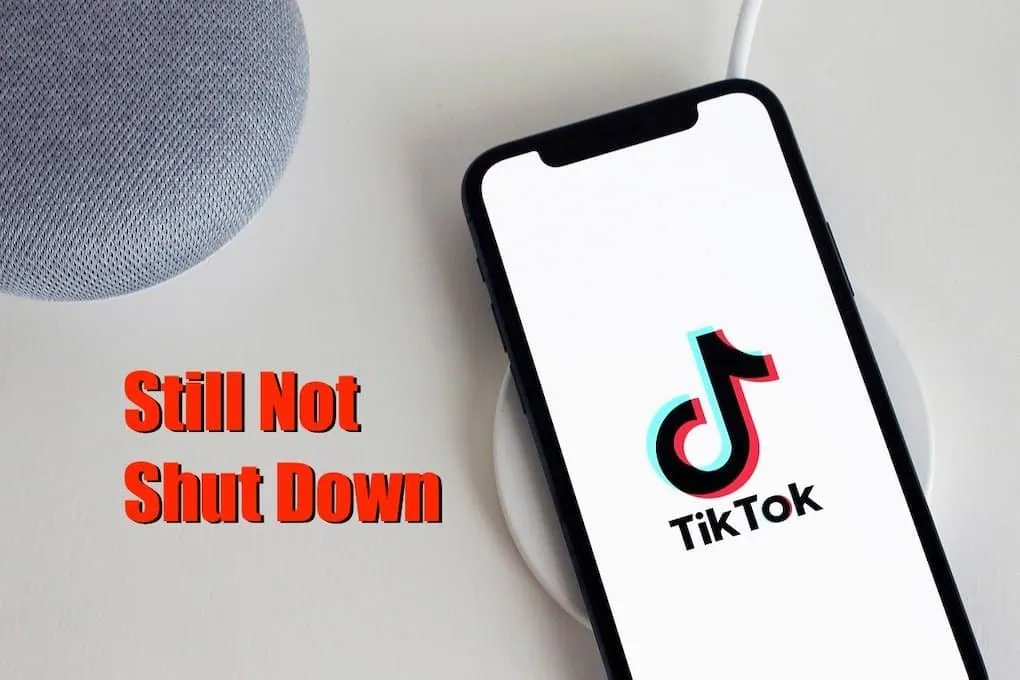 TikTok app on smartphone with wireless charger on white table, emphasizing ongoing social media activity and digital content