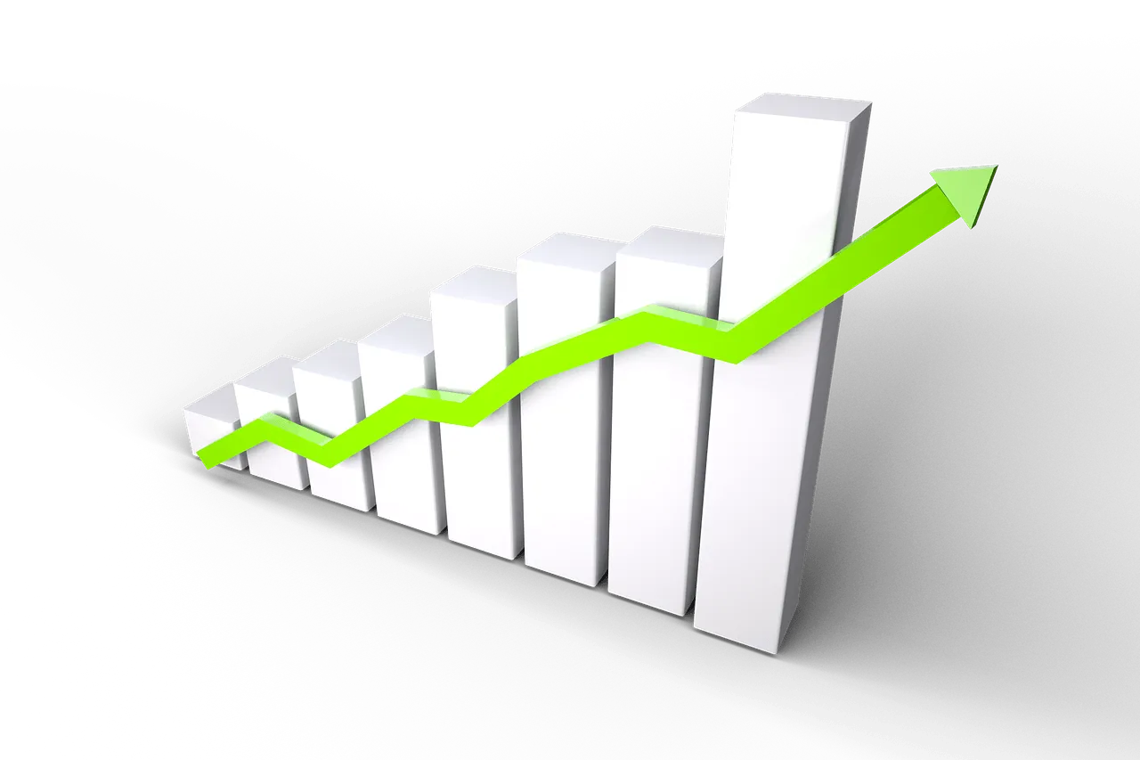 Bar graph with upward trending green arrow representing growth and success in the music or entertainment industry for Hypebot