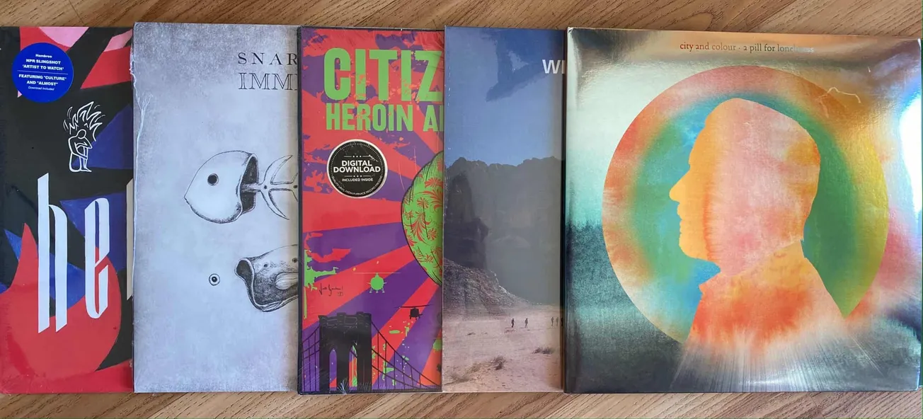 Colorful vinyl record album covers with modern and abstract artwork, showcasing diverse music genres and vibrant designs perf