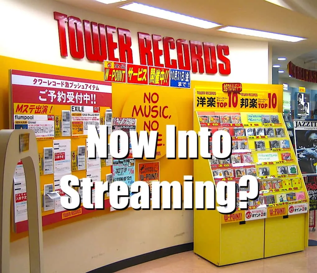 Mp3 music store display at Tower Records with promotional posters and album covers, vibrant yellow and red color scheme, focu