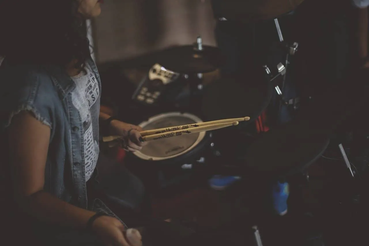 Drummer practicing with drumsticks at home, dark mood, musical instruments, music studio, indie music, band rehearsal, creati