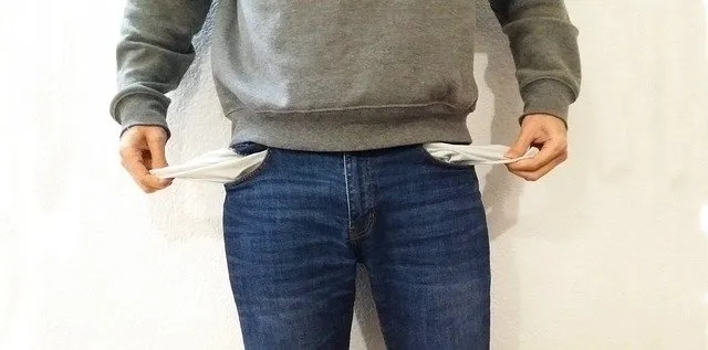 Empty pockets in casual gray sweatshirt and jeans, focused on clothing and fashion.