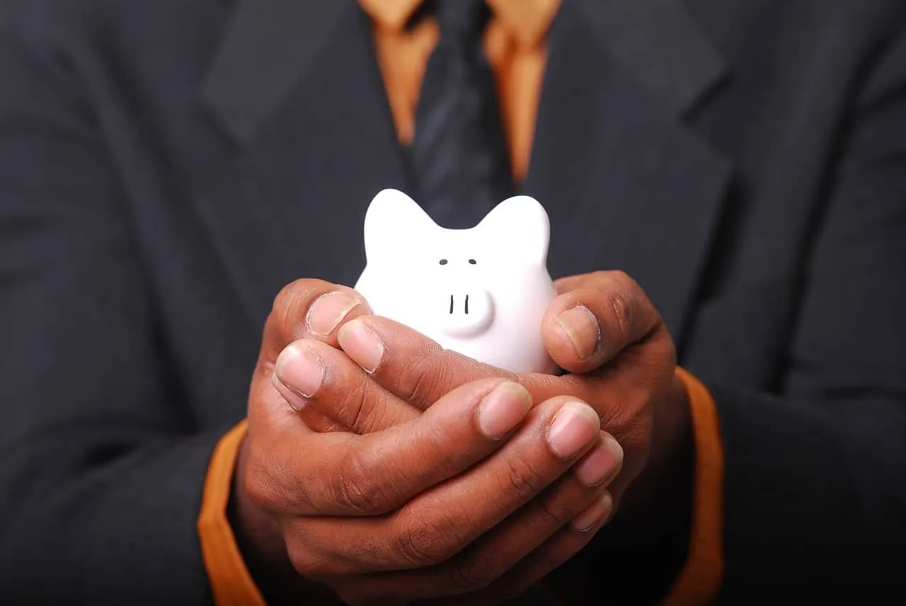 Piggy bank in hands representing savings, finance, and investment concept for business and personal financial management.