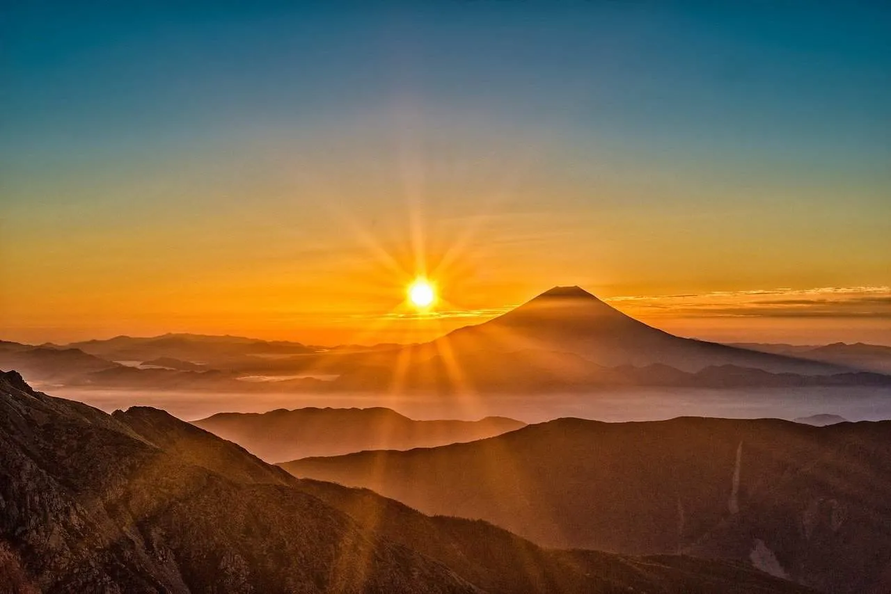 Sunrise over Mount Fuji with vibrant sky and scenic mountain landscape, symbolizing natural beauty and iconic Japan scenery,