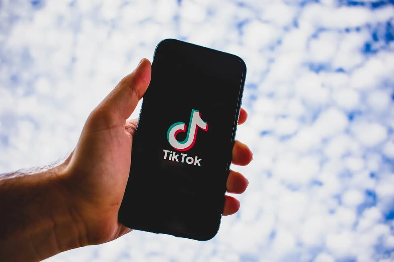 TikTok app on smartphone screen showing logo for social media marketing and content creation.