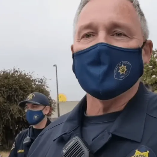 Blue police face masks with law enforcement seal, police officers in uniform outdoors, emphasizing community safety and law e