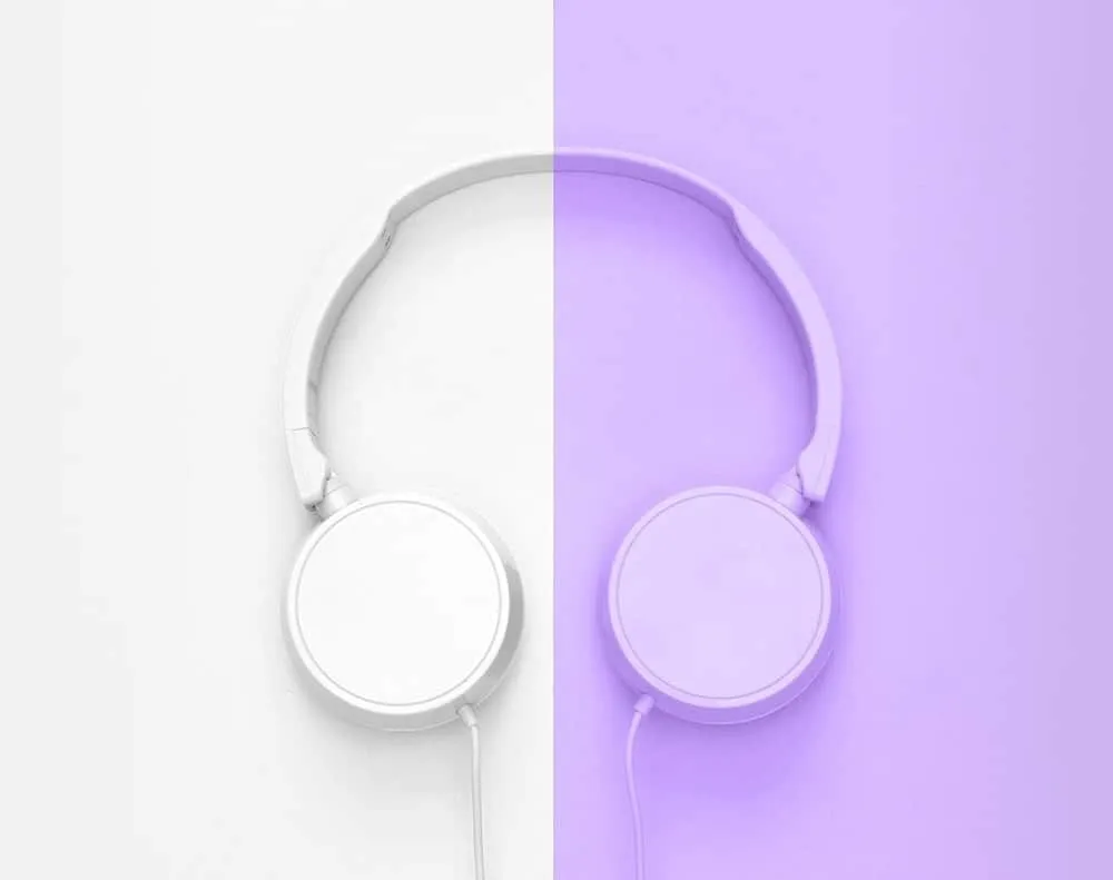 White headphones on split background showcasing modern music technology and digital audio.