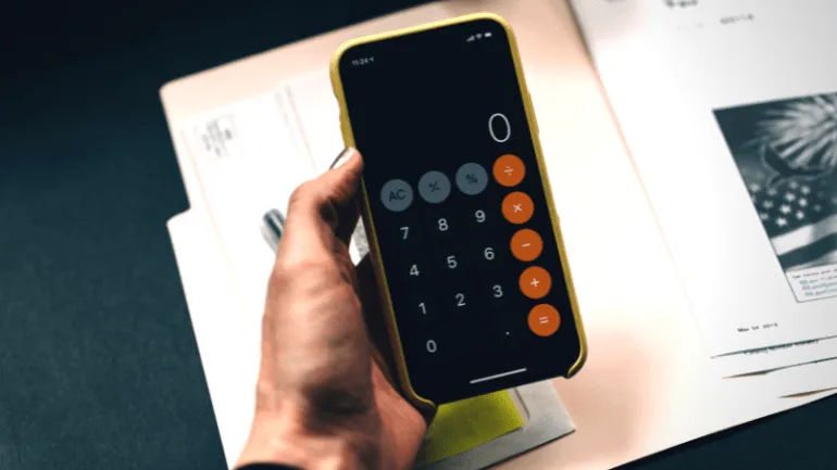 Calculator on smartphone with financial documents in background, financial analysis, business finance, digital tools for budg
