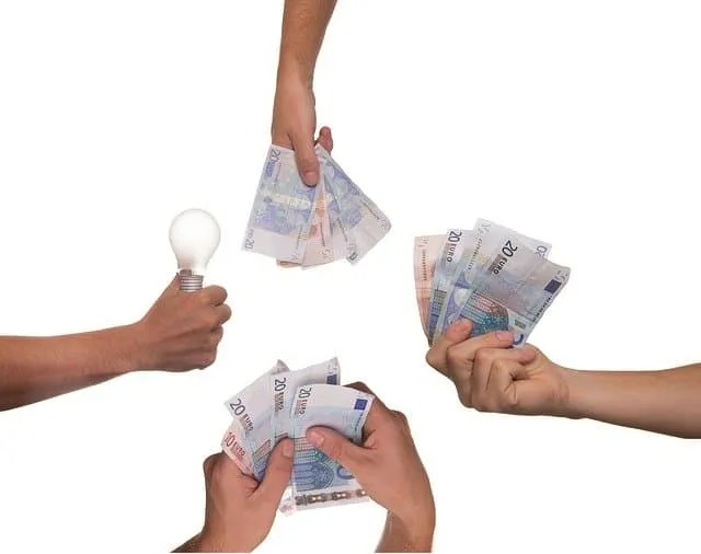 Money exchanging hands with electric bulb, representing innovation or ideas in financial transactions, payment systems, or in