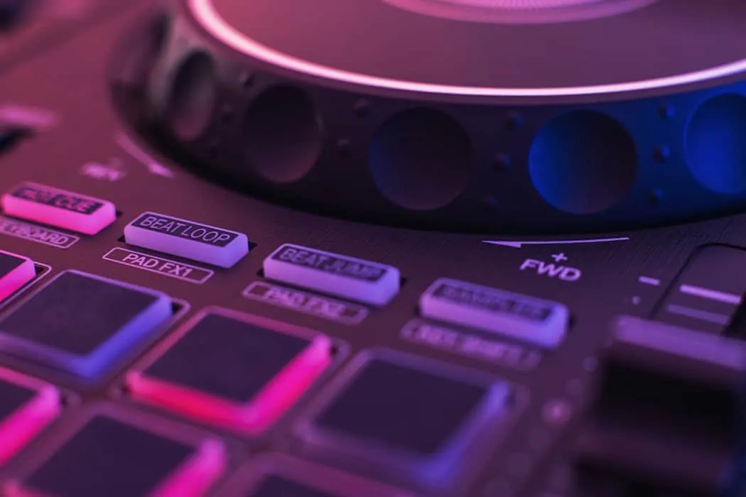 DJ controller with illuminated buttons and rotary knobs for music production, DJing, and live performances, showcasing modern