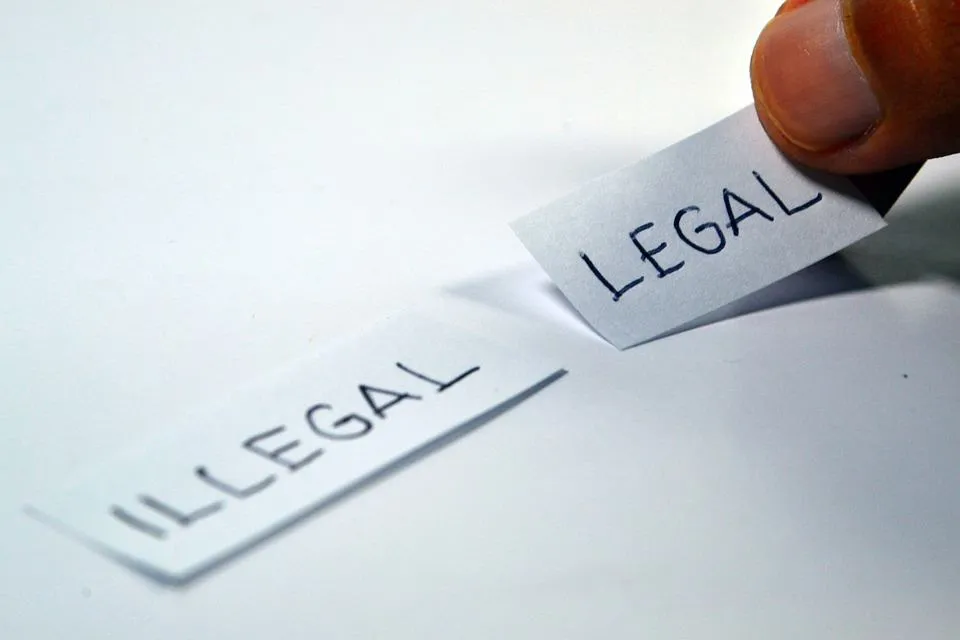 Legal document concept with handwritten "ILLEGAL" and "LEGAL" labels, representing distinctions in law and compliance, releva