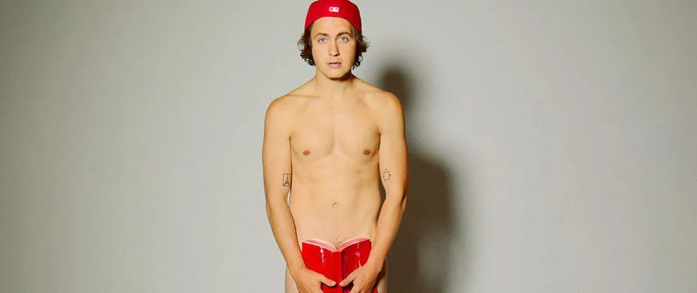 Young male musician with red cap holding a red notebook, promoting music industry and artist branding, branding concept, Hype