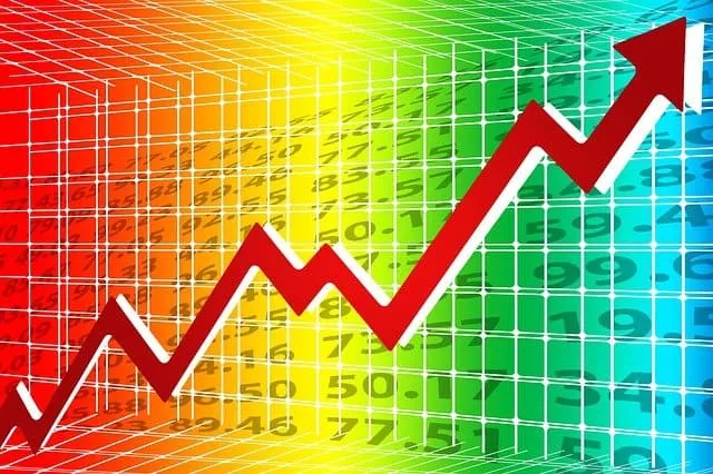 Upward trending graph with red arrow indicating growth, over a colorful digital background.
