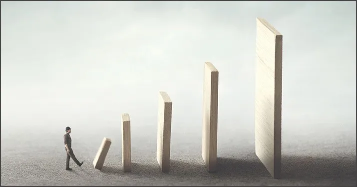 Innovative business growth concept with a person walking towards increasing wooden blocks representing progress and success i