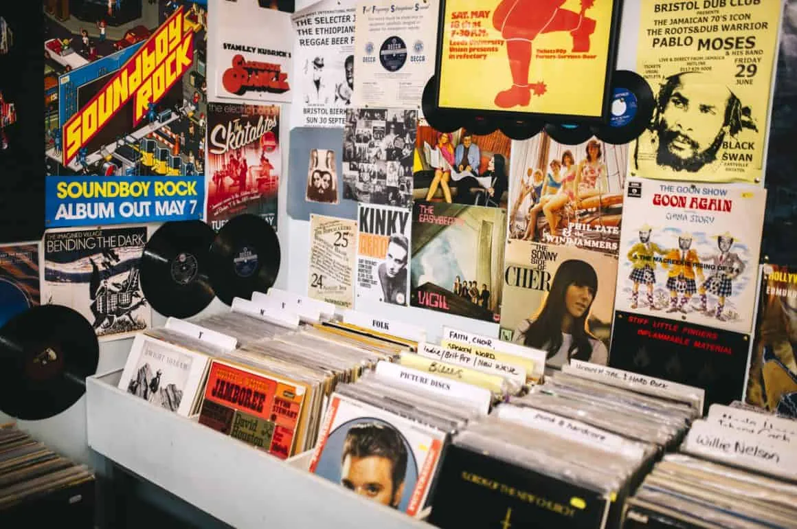 Vintage music and concert posters displayed on a wall at a record shop or music venue.